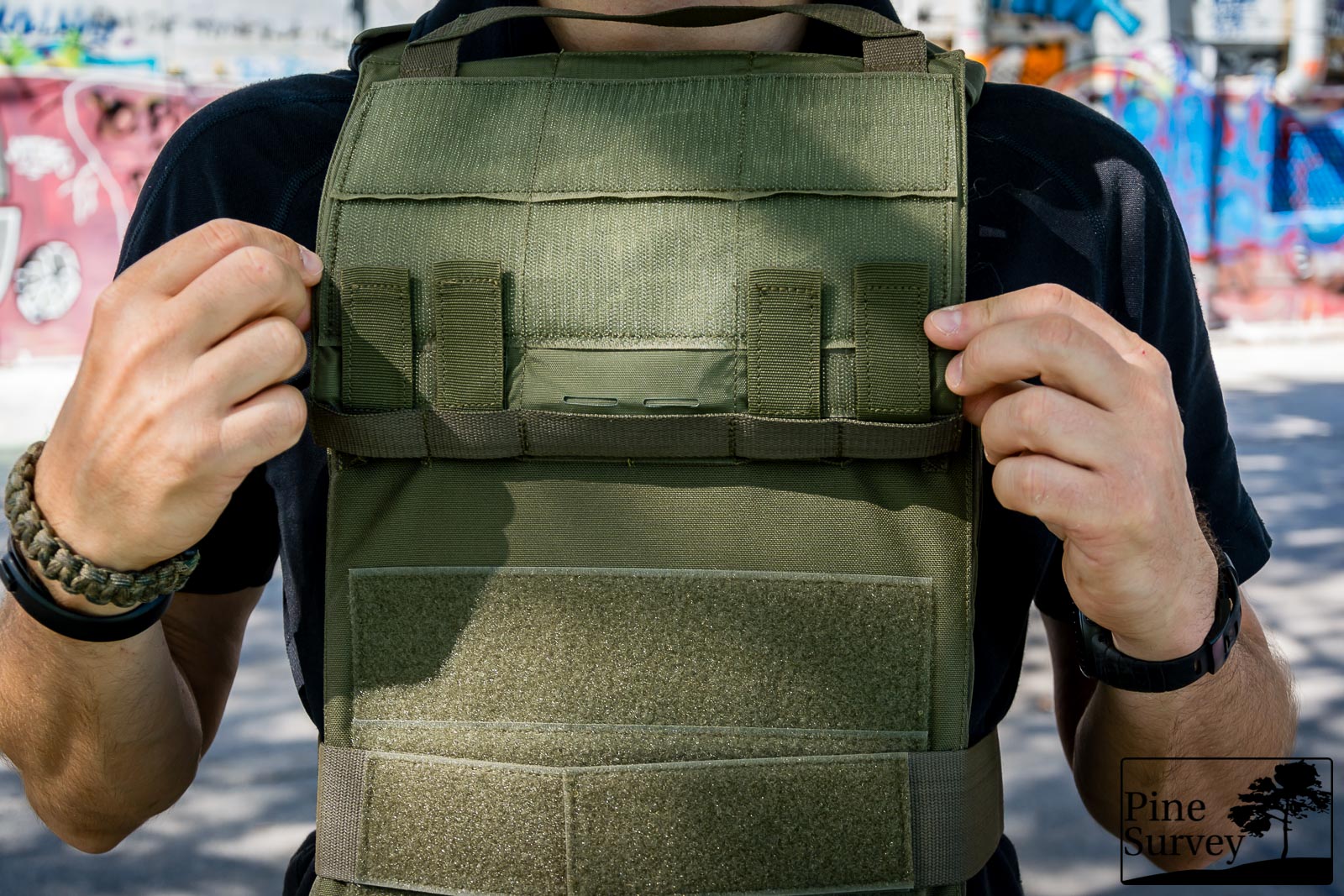 The MOLLE front panel lifted up, showing its attachment